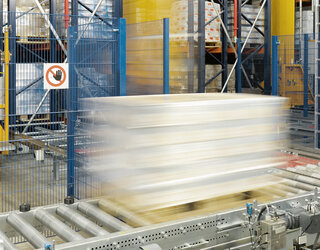 A packed pallet has just been retrieved from the high-bay warehouse and moves on the conveyor system to the retrieval point A packed pallet has just been retrieved from the high-bay warehouse and moves on the conveyor system to the retrieval point