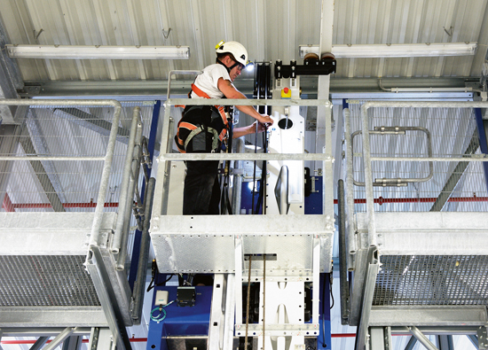 LTW service technician performs maintenance on the stacker crane in the stable maintenance basket LTW service technician performs maintenance on the stacker crane in the stable maintenance basket